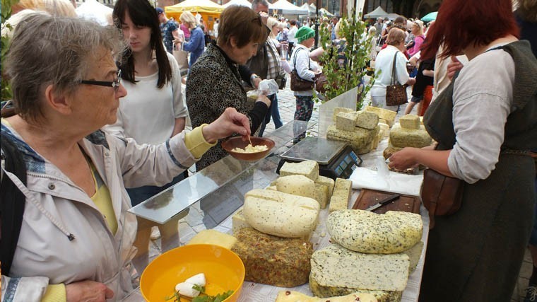 Latvia, Riga, 06.23.2016. The Ligo festival (summer solstice) in the Dome Square. Residents and guests of Riga acquired products from local manufacturers of home - cheese, bread, meat, fish, honey, herbs Yanov, holiday wreaths, as well as handicrafts and ceramics