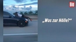 Видео: настойчивый экс-бойфренд лежит на капоте седана, летящего на 110 км/ч